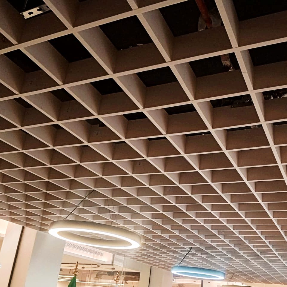 Close-up view of Decrasound PET Box Baffles forming a grid ceiling pattern for acoustic control and modern architectural design.