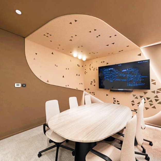 Green patterned Decrasound Acoustiscreen PET wall panels providing sound absorption and visual design in a modern office meeting space.