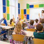 Students raising their hands in a classroom with colourful Decrasound polyester acoustic panels on the walls, improving sound clarity and focus.