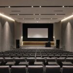 Contemporary university lecture theatre featuring Decrasound Acoustiscreen PET acoustic wall panels for improved speech clarity and reverberation control.