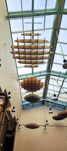 Collection of custom acoustic cloud designs displayed in a commercial acoustic showroom.