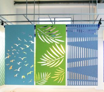 Decorative PET acoustic partition screens creating separation and privacy within an open-plan office environment.